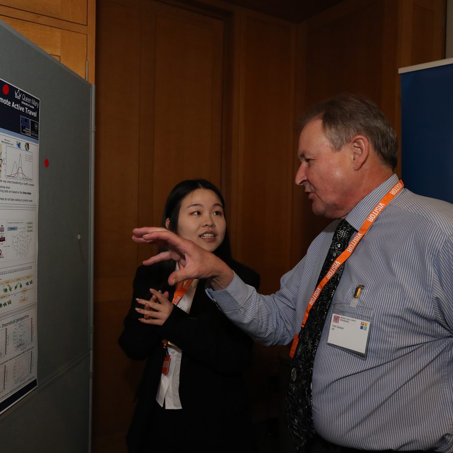 Tingting Yang in conversation with a visitor beside her poster at STEM for BRITAIN in the Houses of Parliament.